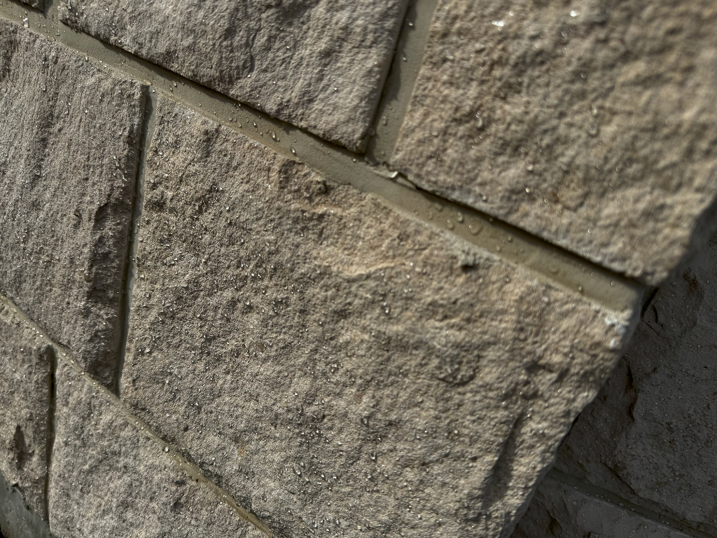 perfect beads of water sit on some split face style limestone on a fountain, the beading was caused by the effectiveness of the waterbased sealer from stonesealer Canada which was installed to the stone. 