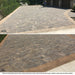 a before and after of a natural stone paver driveway sealed with trident CAT 4 enhancing urethane sealer from trident