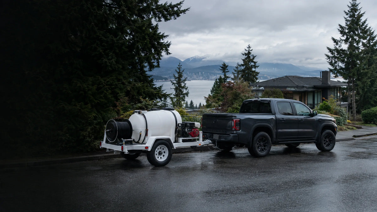 Commercial pressure washing trailer with water tank and hose reel on a Vancouver residential street